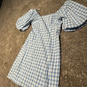 Blue checkered dress, with puff sleeves.